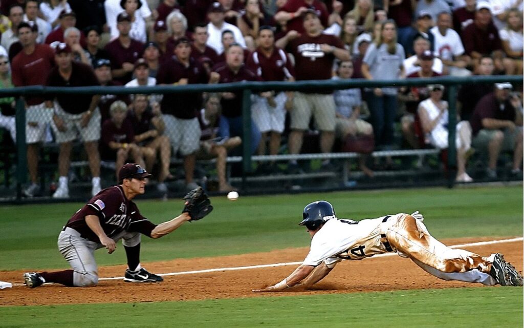 Dramatic moment as a baseball player slides home during a lively game amidst cheering crowd.